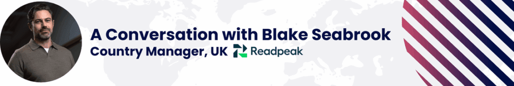 Readpeak UK interview banner featuring a professional headshot alongside the title ‘A Conversation with Blake Seabrook, Country Manager, UK’, displayed on a branded background with global map accents and diagonal graphic lines.
